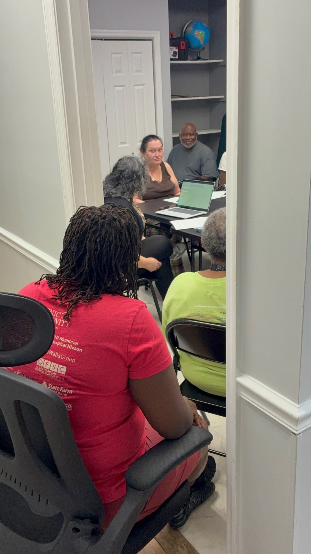 Team members gathered around a table during a recent meeting.