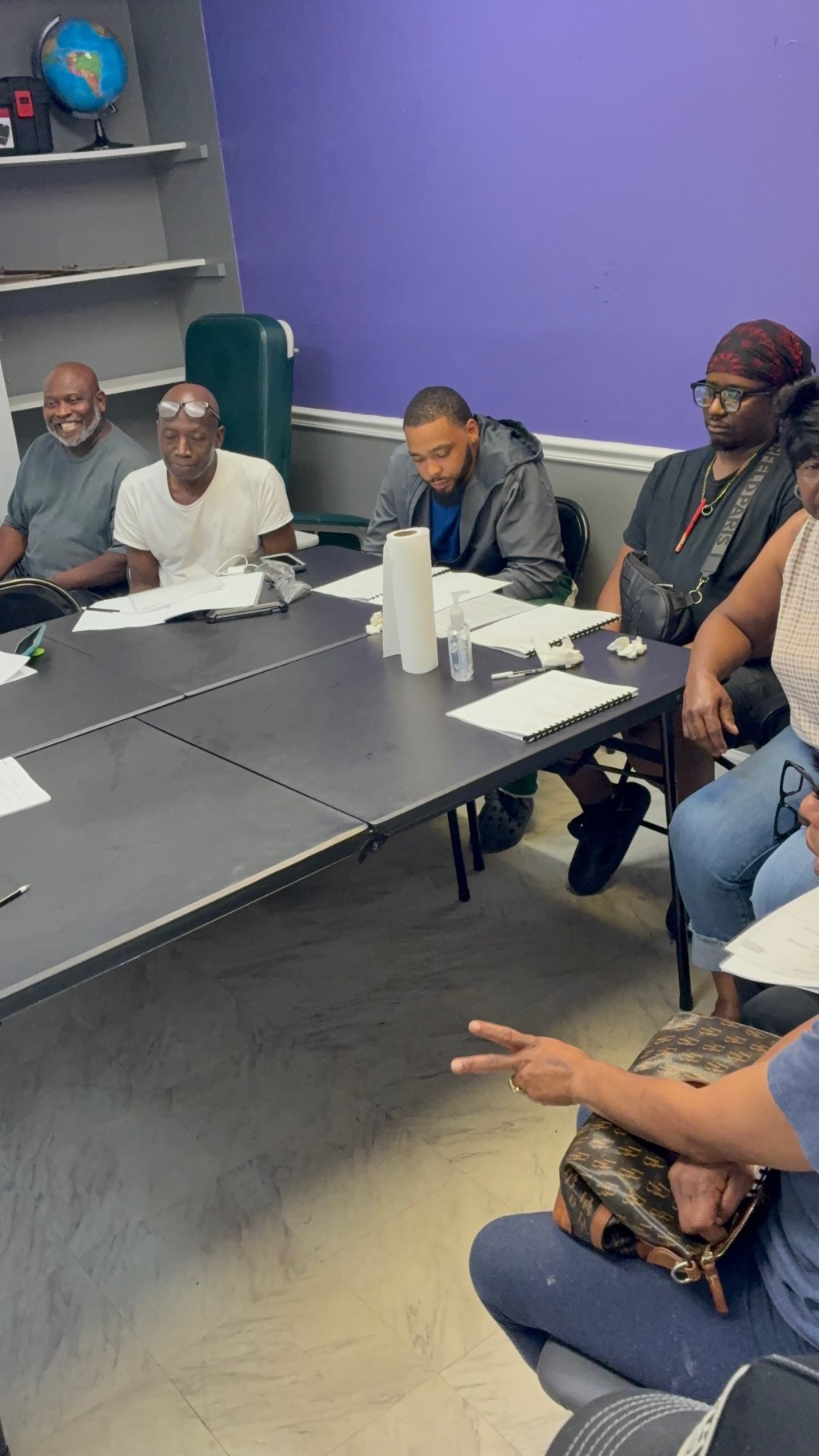 Team members seated around a table during a group discussion.